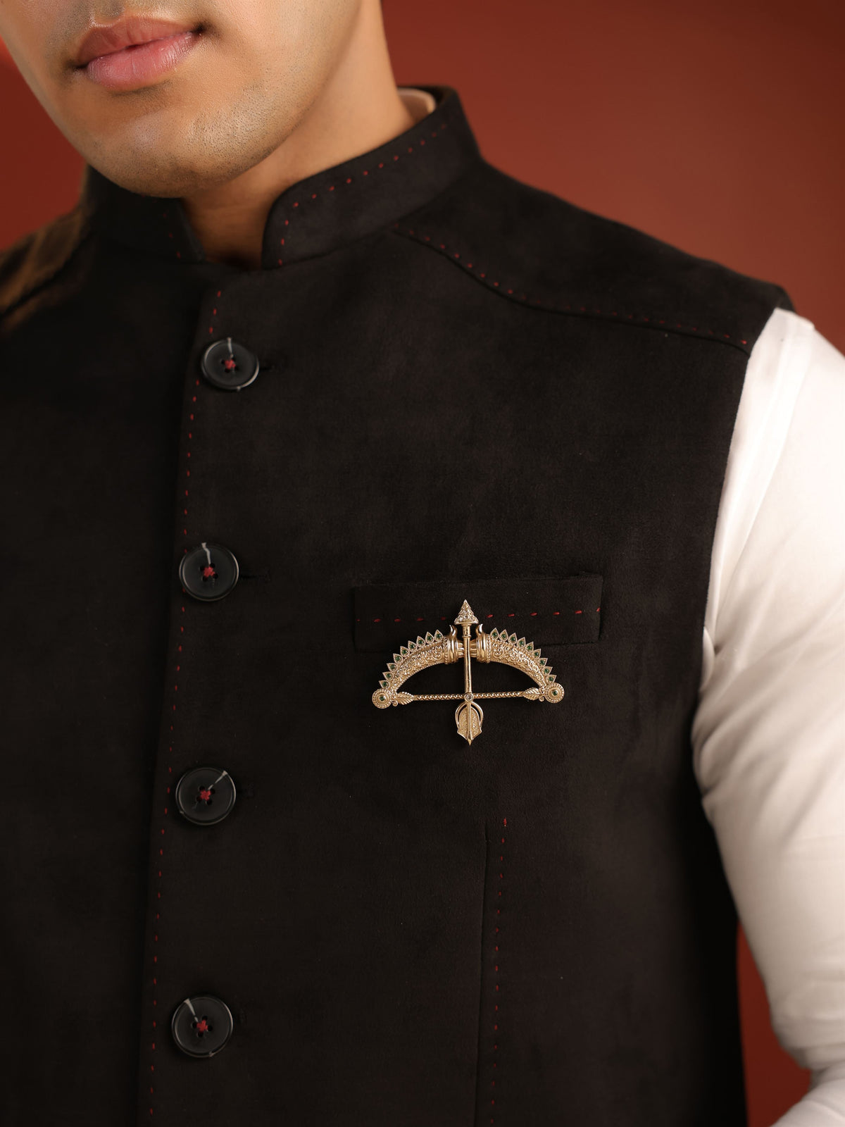 The Emerald Crown Dhanush brooch - antique gold brooch for men with emerald crown dhanush motif, angled view